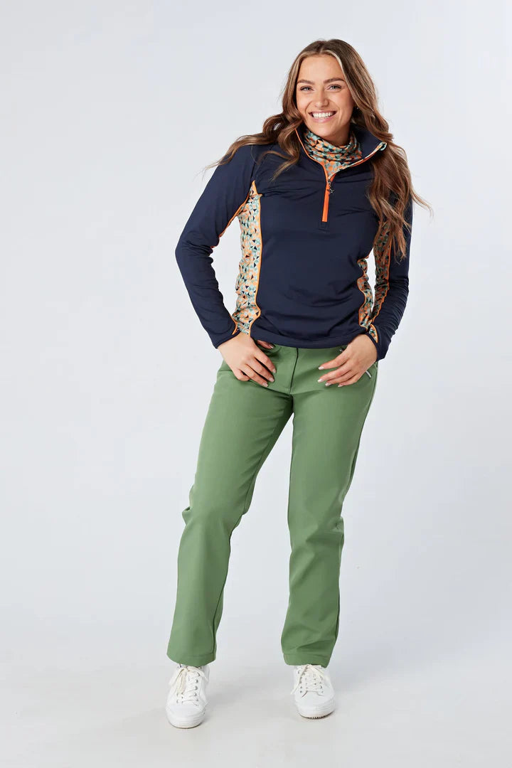 Woman wearing Swing out Sister Moray Windstopper Sage Trousers with green velvet accents and natural waist fit