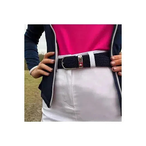 Navy stretch webbed belt with motif buckle worn with white skirt and navy jacket