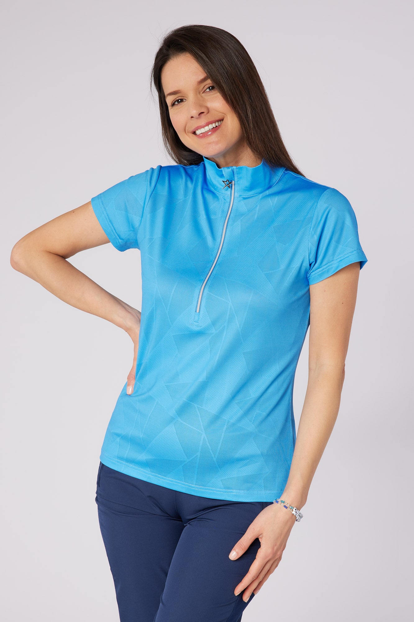 Swing out Sister Embossed Mirage Cap Sleeve Ladies Polo with Zip Neck in Ocean Blue